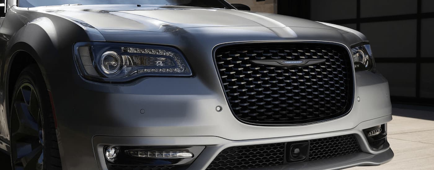 A close up of the front and grille of a silver 2022 Chrysler 300 is shown.