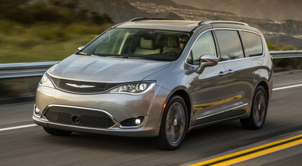 A silver 2017 Chrysler Pacifica is shown from the front at an angle after leaving a used Chrysler dealer.