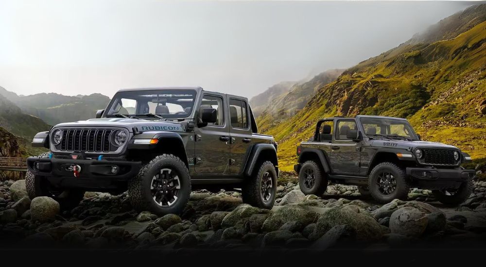 A grey 2024 Jeep Wrangler 4xe gray Wrangler Willys are shown on a foggy day.